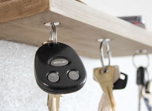 keys hanging on magnets on the shelf