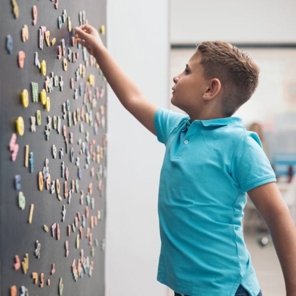 boy in front of the magnetic wall